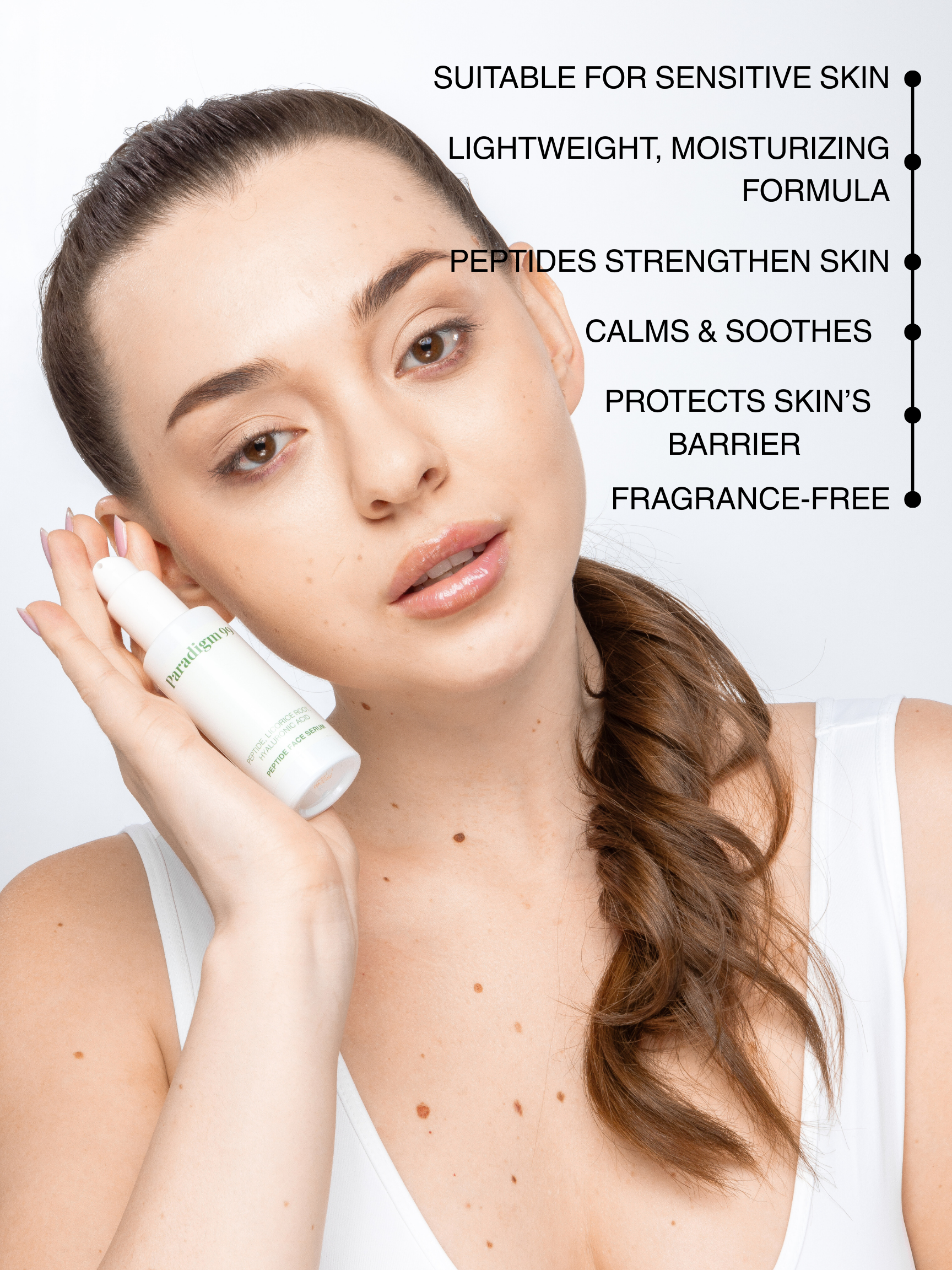 Woman holding a peptide face serum paradigm99 bottle with product features listed above her. Benefits: Suitable for sensitive skin, lightweight, moisturizing formula, peptides strengthen skin, calms & soothes, protects skin`s barrier, fragrance-free