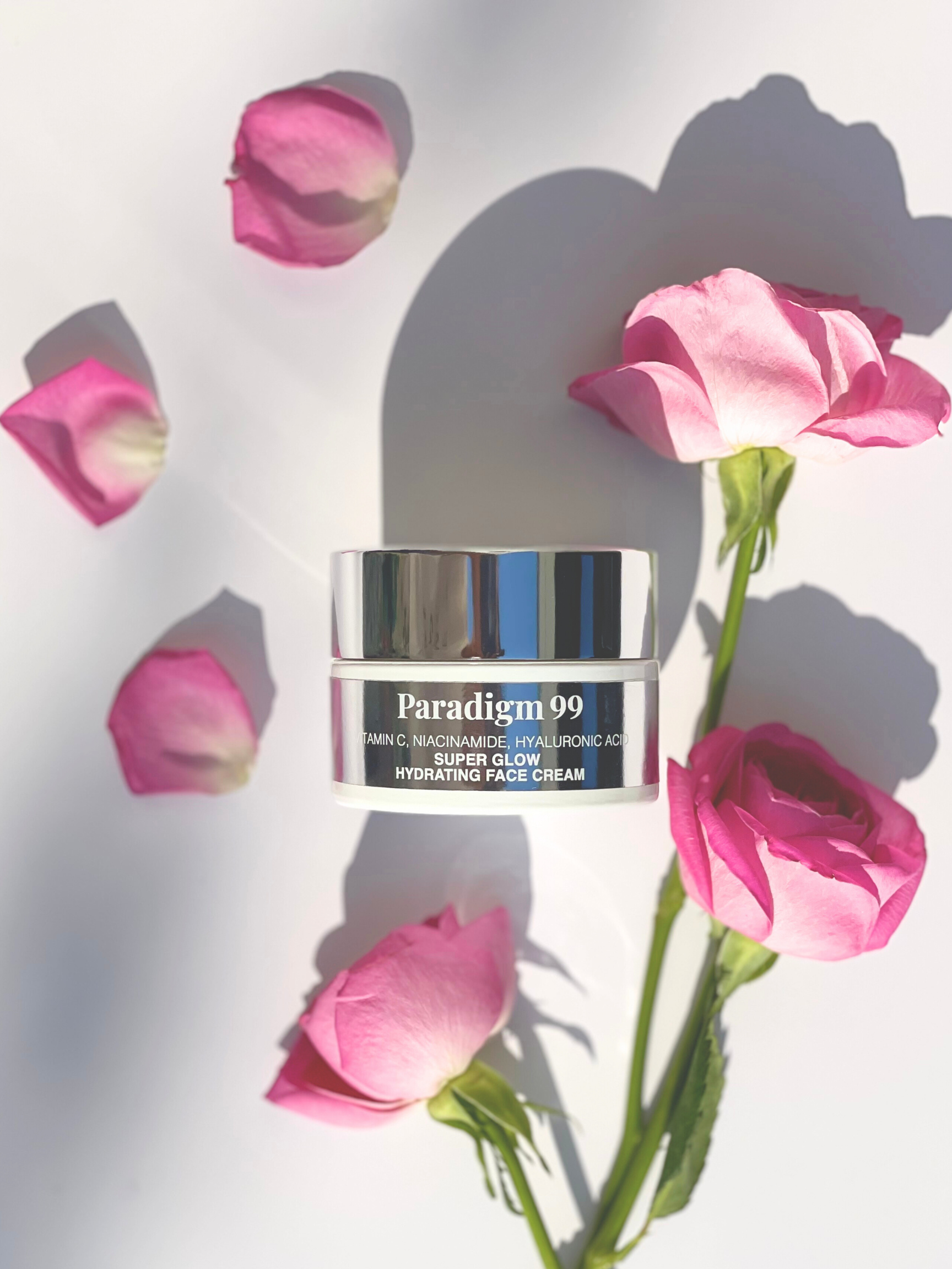 Paradigm 99 Super Glow Hydrating Cream  jar with pink flowers on a light background.